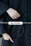 Close-up of a person wearing a Navy Blue One Size Fits All Oversized Water Resistant Windbreaker Jacket by looselyboho, with their hand in a large pocket. The image highlights the size of the pockets with overlay text reading "Big Pockets" and a white arrow pointing to the pocket, emphasizing its oversized fit.