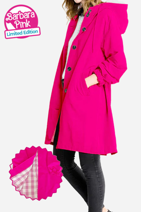 A person is wearing The WJacket's Water Resistant Oversized Hooded Windbreaker Rain Jacket in bright pink, featuring large buttons and pockets. The coat is a 